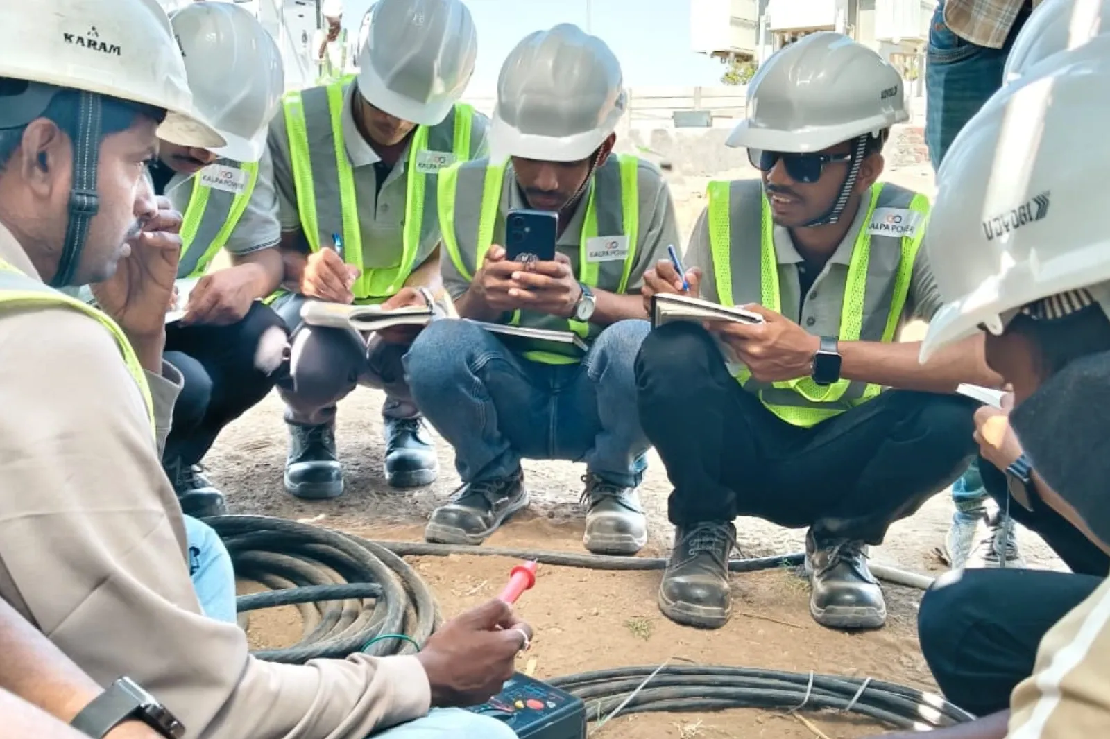 Graduate engineer trainees at Kalpa Power in hard hats on site