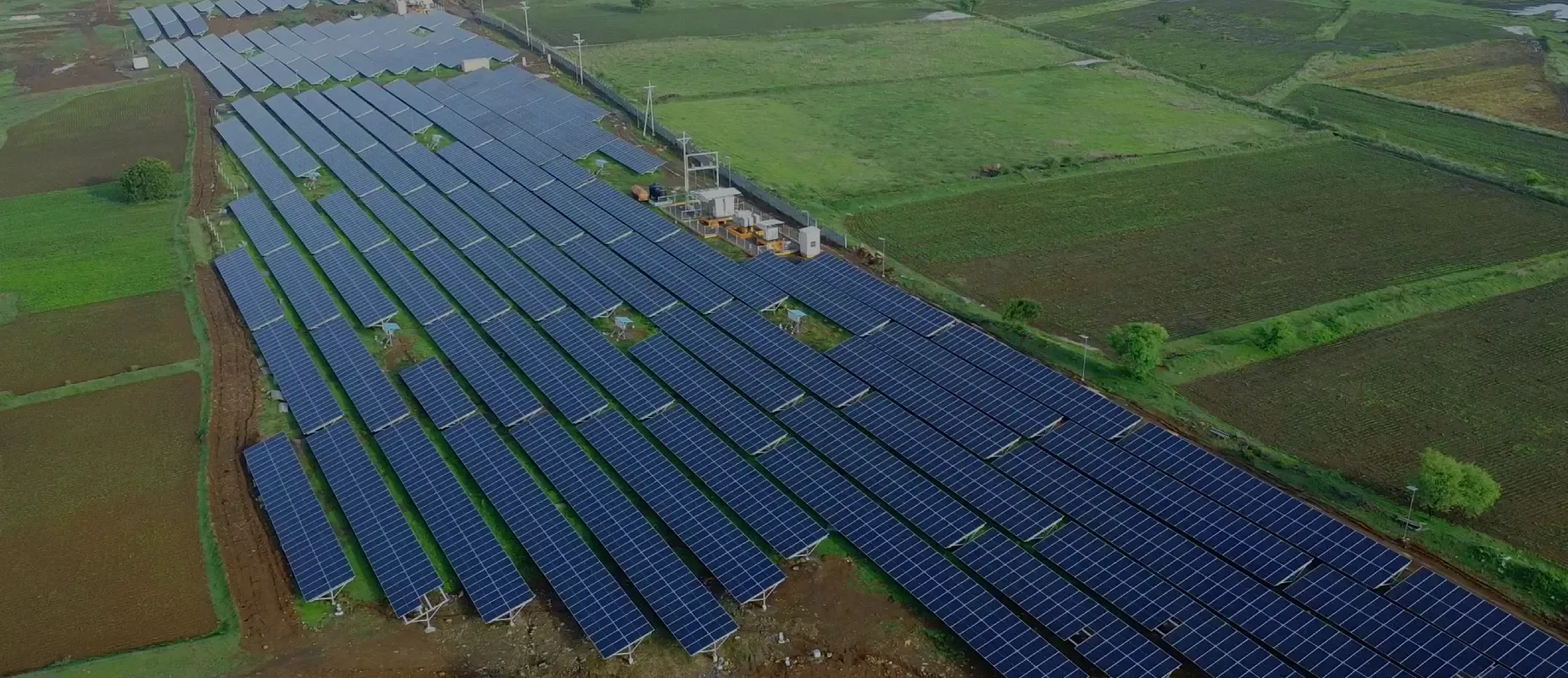 Aerial view of a Kalpa Power open-access solar park set among green farmland in Maharashtra