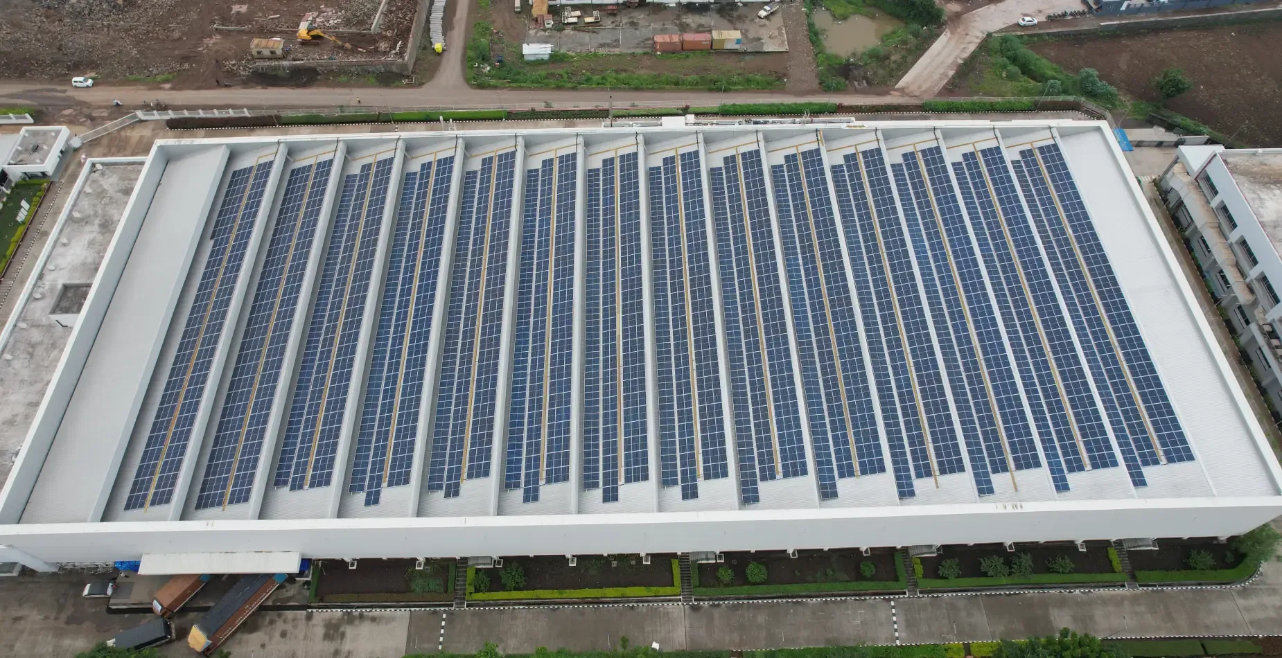 Aerial view of a large industrial rooftop solar plant built by Kalpa Power